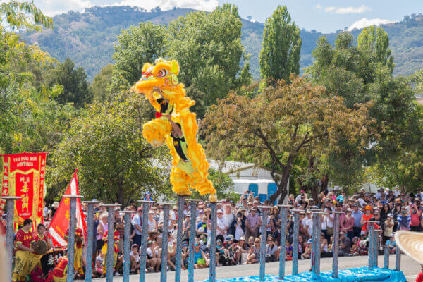 Chinese Dragon Dancers Leaping across pillars at Nundle Australia Easter Festival